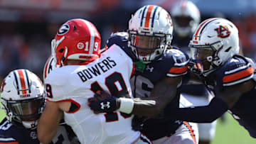 Auburn footballSep 30, 2023; Auburn, Alabama, USA; Georgia Bulldogs tight end Brock Bowers (19) is stopped by Auburn Tigers linebacker Cam Riley (13), cornerback Jaylin Simpson (36), and cornerback D.J. James (4) during the first quarter at Jordan-Hare Stadium. Mandatory Credit: John Reed-USA TODAY Sports