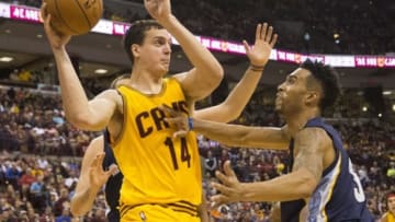 Oct 12, 2015; Columbus, OH, USA; Cleveland Cavaliers center Sasha Kaun (14) sends a pass over defending Memphis Grizzlies guard Courtney Lee (5) at the Schottenstein Center. Memphis won the game 91-81. Mandatory Credit: Greg Bartram-USA TODAY Sports