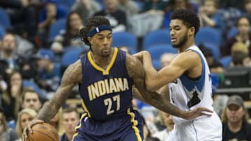 Dec 26, 2015; Minneapolis, MN, USA; Indiana Pacers center Jordan Hill (27) dribbles the ball as Minnesota Timberwolves center Karl-Anthony Towns (32) defends in the first half at Target Center. Mandatory Credit: Jesse Johnson-USA TODAY Sports