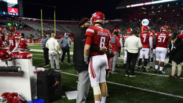PISCATAWAY, NJ - NOVEMBER 10: Strength and conditioning coach Kenny Parker (L) for the Scarlett Knights talks with quarterback Artur Sitkowski #8 against the Michigan Wolverines during the fourth quarter at HighPoint.com Stadium on November 10, 2018 in Piscataway, New Jersey. Michigan won 42-7. (Photo by Corey Perrine/Getty Images)