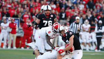 Indiana Hoosiers linebacker D.K. Bonhomme and defensive lineman James Reed Jr. tackle Nebraska Cornhuskers quarterback Luke McCaffrey (Bruce Thorson-USA TODAY Sports)