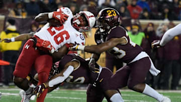 MINNEAPOLIS, MINNESOTA - OCTOBER 12: Coney Durr #16 and Jordan Howden #23 of the Minnesota Gophers tackle Dedrick Mills #26 of the Nebraska Cornhuskers during the third quarter of the game at TCF Bank Stadium on October 12, 2019 in Minneapolis, Minnesota. The Gophers defeated the Cornhuskers 34-7. (Photo by Hannah Foslien/Getty Images)