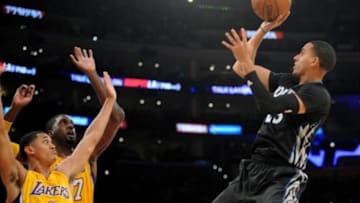 October 28, 2015; Los Angeles, CA, USA; Minnesota Timberwolves guard Kevin Martin (23) shoots against the defense of Los Angeles Lakers guard Jordan Clarkson (6) and center Roy Hibbert (17) during the second half at Staples Center. Mandatory Credit: Gary A. Vasquez-USA TODAY Sports
