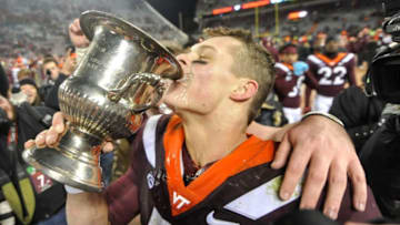 BLACKSBURG, VA - NOVEMBER 23: Quarterback Ryan Willis #5 of the Virginia Tech Hokies celebrates with the Commonwealth Cup following the victory against the Virginia Cavaliers at Lane Stadium on November 23, 2018 in Blacksburg, Virginia. (Photo by Michael Shroyer/Getty Images)