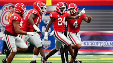 Sep 3, 2022; Atlanta, Georgia, USA; Georgia Bulldogs defensive back Malaki Starks (24) celebrates his interception against Oregon Ducks wide receiver Seven McGee (7) during the first quarter of the Chick-fil-A kickoff game at Mercedes-Benz Stadium. Mandatory Credit: John David Mercer-USA TODAY Sports