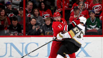RALEIGH, NC - JANUARY 21: Justin Faulk #27 of the Carolina Hurricanes interferes with David Perron #57 of the Vegas Golden Knights during an NHL game on January 21, 2018 at PNC Arena in Raleigh, North Carolina. (Photo by Gregg Forwerck/NHLI via Getty Images)