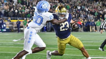 Oct 30, 2021; South Bend, Indiana, USA; Notre Dame Fighting Irish running back Kyren Williams (23) carries the ball as North Carolina Tar Heels cornerback Tony Grimes (20) defends in the fourth quarter at Notre Dame Stadium. Mandatory Credit: Matt Cashore-USA TODAY Sports