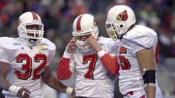 --Caption: PHOTO BY SAM UPSHAW, THE COURIER-JOURNALFrank Moreau, left, and Anthony Byrd, right, consoled U of L quarterback Chris Redman after he threw his third interception.--Text LOCAL STAFF/DEC. 30, 1999/SAM UPSHAW JR. PHOTO U of L's Frank Moreau, #32, left, and Anthony Byrd, #65, consoled Chris Redman, #7, center, after he threw an interception to the lose the game against Boise.Moreau