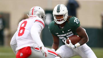 EAST LANSING, MI - NOVEMBER 10: Darrell Stewart Jr. #25 of the Michigan State Spartans tries to avoid the tackle of Kendall Sheffield #8 of the Ohio State Buckeyes during the first half at Spartan Stadium on November 10, 2018 in East Lansing, Michigan. (Photo by Gregory Shamus/Getty Images)