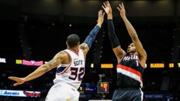 Mar 27, 2014; Atlanta, GA, USA; Portland Trail Blazers forward LaMarcus Aldridge (12) shoots over Atlanta Hawks forward Mike Scott (32) in the first half at Philips Arena. Mandatory Credit: Daniel Shirey-USA TODAY Sports