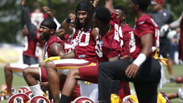 Jul 28, 2016; Richmond, VA, USA; Washington Redskins cornerback Josh Norman (L) and teammates stretch on the field prior to afternoon practice on day one of training camp at Bon Secours Washington Redskins Training Center. Mandatory Credit: Geoff Burke-USA TODAY Sports
