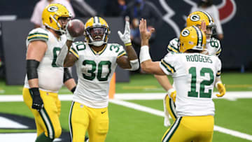 Oct 25, 2020; Houston, Texas, USA; Green Bay Packers running back Jamaal Williams (30) celebrates with quarterback Aaron Rodgers (12) after scoring a touchdown during the fourth quarter against the Houston Texans at NRG Stadium. Mandatory Credit: Troy Taormina-USA TODAY Sports