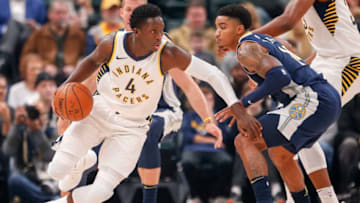 INDIANAPOLIS, IN - DECEMBER 10: Victor Oladipo #4 of the Indiana Pacers dribbles the ball against Gary Harris #14 of the Denver Nuggets at Bankers Life Fieldhouse on December 10, 2017 in Indianapolis, Indiana. NOTE TO USER: User expressly acknowledges and agrees that, by downloading and or using this photograph, User is consenting to the terms and conditions of the Getty Images License Agreement. (Photo by Michael Hickey/Getty Images)