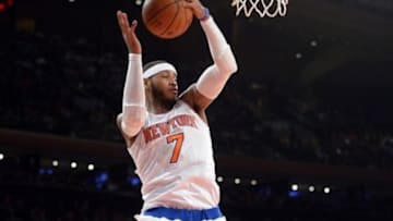 Feb 7, 2014; New York, NY, USA; New York Knicks small forward Carmelo Anthony (7) grabs a rebound against the Denver Nuggets during the first half at Madison Square Garden. Mandatory Credit: Joe Camporeale-USA TODAY Sports