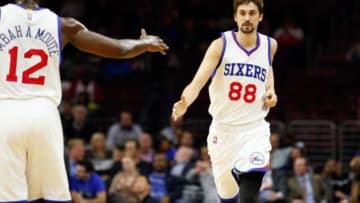 Dec 1, 2014; Philadelphia, PA, USA; Philadelphia 76ers guard Alexey Shved (88) scores and is congratulated by forward Luc Richard Mbah a Moute (12) during the first quarter of a game against the San Antonio Spurs at Wells Fargo Center. Mandatory Credit: Bill Streicher-USA TODAY Sports
