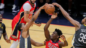 NEW ORLEANS, LA - MAY 06: New Orleans Pelicans guard Jrue Holiday (11) has a shot blocked by Golden State Warriors forward Kevin Durant (35) and forward Kevon Looney (5) during game 4 of the NBA Western Conference Semifinals at Smoothie King Center in New Orleans, LA on May 06, 2018. (Photo by Stephen Lew/Icon Sportswire via Getty Images)