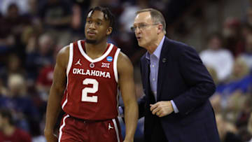 COLUMBIA, SOUTH CAROLINA - MARCH 22: Head coach Lon Kruger of the Oklahoma Sooners speaks to Aaron Calixte #2 in the second half against the Mississippi Rebels during the first round of the 2019 NCAA Men's Basketball Tournament at Colonial Life Arena on March 22, 2019 in Columbia, South Carolina. (Photo by Streeter Lecka/Getty Images)