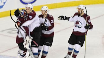 CALGARY, AB - APRIL 19: Colorado Avalanche goaltender Philipp Grubauer (31) greets teammate defenseman Nikita Zadorov (16), center Nathan MacKinnon (29) and Colorado Avalanche defenseman Patrik Nemeth (12) after defeating the Calgary Flames 5-1 to take the series 4-1 in the at the Scotiabank Saddledome for game five playoffs April 19, 2019. (Photo by Andy Cross/MediaNews Group/The Denver Post via Getty Images)