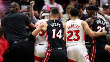 Tyler Herro #14 of the Miami Heat and Fred VanVleet #23 of the Toronto Raptors help pull away teammates after Caleb Martin #16 of the Miami Heat and Christian Koloko #35 of the Toronto Raptors get into an altercation(Photo by Megan Briggs/Getty Images)