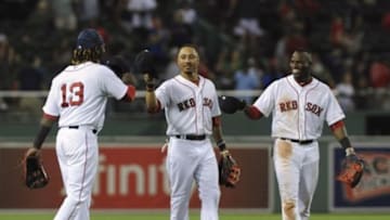 Aug 18, 2015; Boston, MA, USA; Boston Red Sox left fielder Hanley Ramirez (13) and center fielder Mookie Betts (50) and right fielder Rusney Castillo (38) celebrate after defeating the Cleveland Indians at Fenway Park. Mandatory Credit: Bob DeChiara-USA TODAY Sports