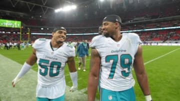Sep 28, 2014; London, UNITED KINGDOM; Miami Dolphins defensive ends Olivier Vernon (50) and Derrick Shelby (79) react after the NFL International Series game against the Oakland Raiders at Wembley Stadium. The Dolphins defeated the Raiders 38-14. Mandatory Credit: Kirby Lee-USA TODAY Sports