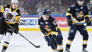 Erie Otters forward Dylan Edwards, center, skates between Hamilton Bulldogs forward Florian Xhekaj, left, and teammate Liam Gilmartin, right, inside Erie Insurance Arena in Erie on Feb. 28, 2023.P5otters022823