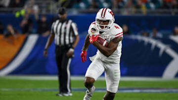 MIAMI GARDENS, FL - DECEMBER 30: A.J. Taylor #4 of the Wisconsin Badgers carries during the first half of the 2017 Capital One Orange Bowl against the Miami Hurricanes at Hard Rock Stadium on December 30, 2017 in Miami Gardens, Florida. (Photo by Rob Foldy/Getty Images)