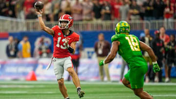 Sep 3, 2022; Atlanta, Georgia, USA; Georgia Bulldogs quarterback Stetson Bennett (13) passes against Oregon Ducks linebacker Mase Funa (18) during the first quarter at Mercedes-Benz Stadium. Mandatory Credit: Dale Zanine-USA TODAY Sports