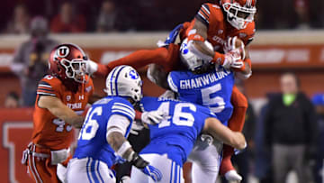 SALT LAKE CITY, UT - NOVEMBER 24: Dayan Ghanwoloku #5 of the Brigham Young Cougars tackles the leaping TJ Green #4 of the Utah Utes in the second half of a game at Rice-Eccles Stadium on November 24, 2018 in Salt Lake City, Utah. (Photo by Gene Sweeney Jr/Getty Images)