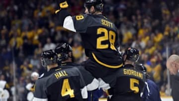 Jan 31, 2016; Nashville, TN, USA; Pacific Division forward John Scott (28) of the Montreal Canadiens is picked up by his teammates after beating the Atlantic Division during the championship game of the 2016 NHL All Star Game at Bridgestone Arena. Mandatory Credit: Christopher Hanewinckel-USA TODAY Sports