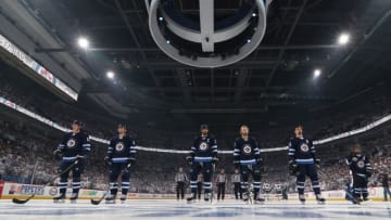 WINNIPEG, MB - APRIL 20: Tyler Myers #57, Jacob Trouba #8, Blake Wheeler #26, Kyle Connor #81 and Mark Scheifele #55 of the Winnipeg Jets stand on the ice prior to puck drop against the Minnesota Wild in Game Five of the Western Conference First Round during the 2018 NHL Stanley Cup Playoffs at the Bell MTS Place on April 20, 2018 in Winnipeg, Manitoba, Canada. (Photo by Jonathan Kozub/NHLI via Getty Images)