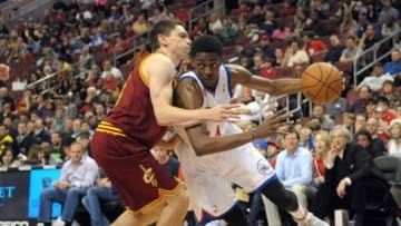 Apr 14, 2013; Philadelphia, PA, USA; Philadelphia 76ers shooting guard Justin Holiday (14) drives against Cleveland Cavaliers point guard Chris Quinn (20) during the fourth quarter at the Wells Fargo Center. The 76ers defeated the Cavaliers, 91-77. Mandatory Credit: Eric Hartline-USA TODAY Sports