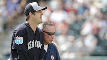 Mar 30, 2016; Lake Buena Vista, FL, USA; Trainers attend to New York Yankees relief pitcher Andrew Miller (left) after he was hit by a line drive back to the mound during the seventh inning of a spring training baseball game against the Atlanta Braves at Champion Stadium. Mandatory Credit: Reinhold Matay-USA TODAY Sports