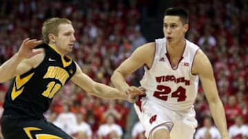 Jan 20, 2015; Madison, WI, USA; Wisconsin Badgers guard Bronson Koenig (24) brings the ball down the floor as Iowa Hawkeyes guard Mike Gesell (10) defends at the Kohl Center. Wisconsin defeated Iowa 82-50. Mandatory Credit: Mary Langenfeld-USA TODAY Sports