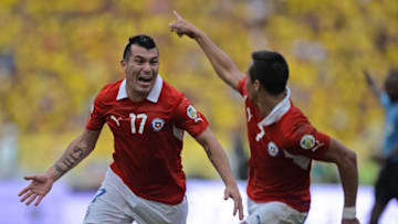 Chile's forward Alexis Sanchez (R) celebrates with teammate Gary Medel after scoring against Colombia during their Brazil 2014 FIFA World Cup South American qualifier match, in Barranquilla, Colombia, on October 11, 2013.AFP PHOTO / EITAN ABRAMOVICH (Photo credit should read EITAN ABRAMOVICH/AFP/Getty Images)