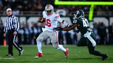Nov 8, 2014; East Lansing, MI, USA; Ohio State Buckeyes quarterback J.T. Barrett (16) runs the ball during the first quarter against the Michigan State Spartans at Spartan Stadium. Mandatory Credit: Andrew Weber-USA TODAY Sports