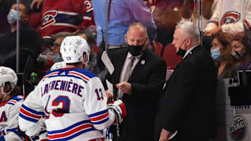 MONTREAL, QC - OCTOBER 16: New York Rangers head coach Gerard Gallant (C) and assistant coach Mike Kelly (R) speak with Alexis Lafrenière #13 during the third period against the Montreal Canadiens at Centre Bell on October 16, 2021 in Montreal, Canada. The New York Rangers defeated the Montreal Canadiens 3-1. (Photo by Minas Panagiotakis/Getty Images)