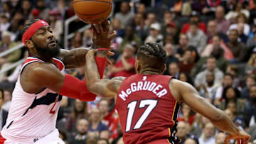 WASHINGTON, DC - OCTOBER 18: John Wall #2 of the Washington Wizards is fouled by Rodney McGruder #17 of the Miami Heat during the second half at Capital One Arena on October 18, 2018 in Washington, DC. NOTE TO USER: User expressly acknowledges and agrees that, by downloading and or using this photograph, User is consenting to the terms and conditions of the Getty Images License Agreement. (Photo by Will Newton/Getty Images)