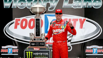 BRISTOL, TN - APRIL 16: Kyle Busch, driver of the #18 Skittles Toyota, poses with the trophy after winning the rain delayed Monster Energy NASCAR Cup Series Food City 500 at Bristol Motor Speedway on April 16, 2018 in Bristol, Tennessee. (Photo by Sean Gardner/Getty Images)