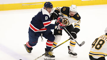 Apr 8, 2021; Washington, District of Columbia, USA; Washington Capitals left wing Alex Ovechkin (8) and Boston Bruins defenseman Connor Clifton (75) battle for the puck in the second period at Capital One Arena. Mandatory Credit: Geoff Burke-USA TODAY Sports