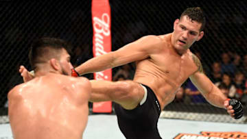 UNIONDALE, NY - JULY 22: (R-L) Chris Weidman kicks Kelvin Gastelum in their middleweight bout during the UFC Fight Night event inside the Nassau Veterans Memorial Coliseum on July 22, 2017 in Uniondale, New York. (Photo by Josh Hedges/Zuffa LLC/Zuffa LLC via Getty Images)