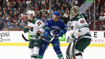 VANCOUVER, BC - DECEMBER 4: Jonas Brodin #25 of the Minnesota Wild and Brock Boeser #6 of the Vancouver Canucks stand in front of Devan Dubnyk #40 of the Minnesota Wild during their NHL game at Rogers Arena December 4, 2018 in Vancouver, British Columbia, Canada. (Photo by Jeff Vinnick/NHLI via Getty Images)"n