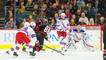 Feb 21, 2020; Raleigh, North Carolina, USA; Carolina Hurricanes center Martin Necas (88) shot is blocked by New York Rangers defenseman Tony DeAngelo (77) during the first period at PNC Arena. Mandatory Credit: James Guillory-USA TODAY Sports