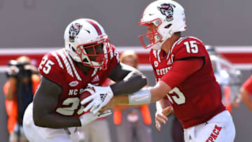 RALEIGH, NC - SEPTEMBER 29: Ryan Finley #15 hands-off to Reggie Gallaspy II #25 of the North Carolina State Wolfpack during their game against the Virginia Cavaliers at Carter-Finley Stadium on September 29, 2018 in Raleigh, North Carolina. NC State won 35-21. (Photo by Lance King/Getty Images)