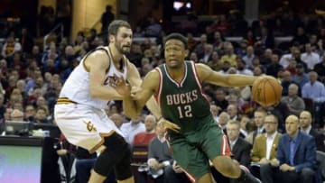 Dec 2, 2014; Cleveland, OH, USA; Milwaukee Bucks forward Jabari Parker (12) drives against Cleveland Cavaliers forward Kevin Love (0) in the second quarter at Quicken Loans Arena. Mandatory Credit: David Richard-USA TODAY Sports