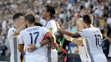 September 11, 2016; Carson, CA, USA; Los Angeles Galaxy forward Alan Gordon (9) celebrates with forward Robbie Rogers (14), midfielder Sebastian Lletget (17) and forward Giovani dos Santos (10) his goal scored against Orlando City FC during the first half at StubHub Center. Mandatory Credit: Gary A. Vasquez-USA TODAY Sports