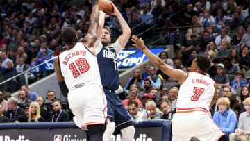 Dallas Mavericks guard Luka Doncic (77) shoots over Miami Heat center Bam Adebayo (13) and Miami Heat guard Kyle Lowry (7)(Kevin Jairaj-USA TODAY Sports)