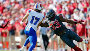 NORMAN, OK - OCTOBER 15: Defensive lineman Marcus Stripling #33 of the Oklahoma Sooners gets spun around as he gets a hold of 1uarterback Jason Bean #17 of the Kansas Jayhawks in the second quarter at Gaylord Family Oklahoma Memorial Stadium on October 15, 2022 in Norman, Oklahoma. Oklahoma won 52-42. (Photo by Brian Bahr/Getty Images)