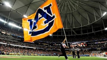 Dec 7, 2013; Atlanta, GA, USA; Auburn Tigers cheerleaders run the flag in the end zone after the 2013 SEC Championship game against the Missouri Tigers at Georgia Dome. The Auburn Tigers defeated the Missouri Tigers 59-42. Mandatory Credit: Kevin Liles-USA TODAY Sports