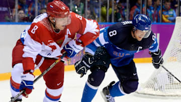 Finland's Teemu Selanne (R) vies with Russia's Alexander Ovechkin during the Men's Ice Hockey Play-offs Quarterfinals match between Finland and Russia at the Bolshoy Ice Dome during the Sochi Winter Olympics on February 19, 2014. Finland won 3-1. AFP PHOTO / JONATHAN NACKSTRAND (Photo credit should read JONATHAN NACKSTRAND/AFP via Getty Images)